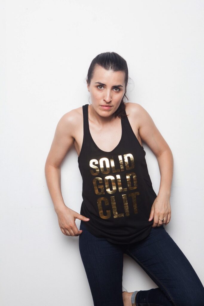Sophia Wallace indossa una canotta nera con la scritta dorata Solid Gold Clit