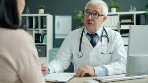 Medico durante un colloquio con una paziente adulta in uno studio sanitario.